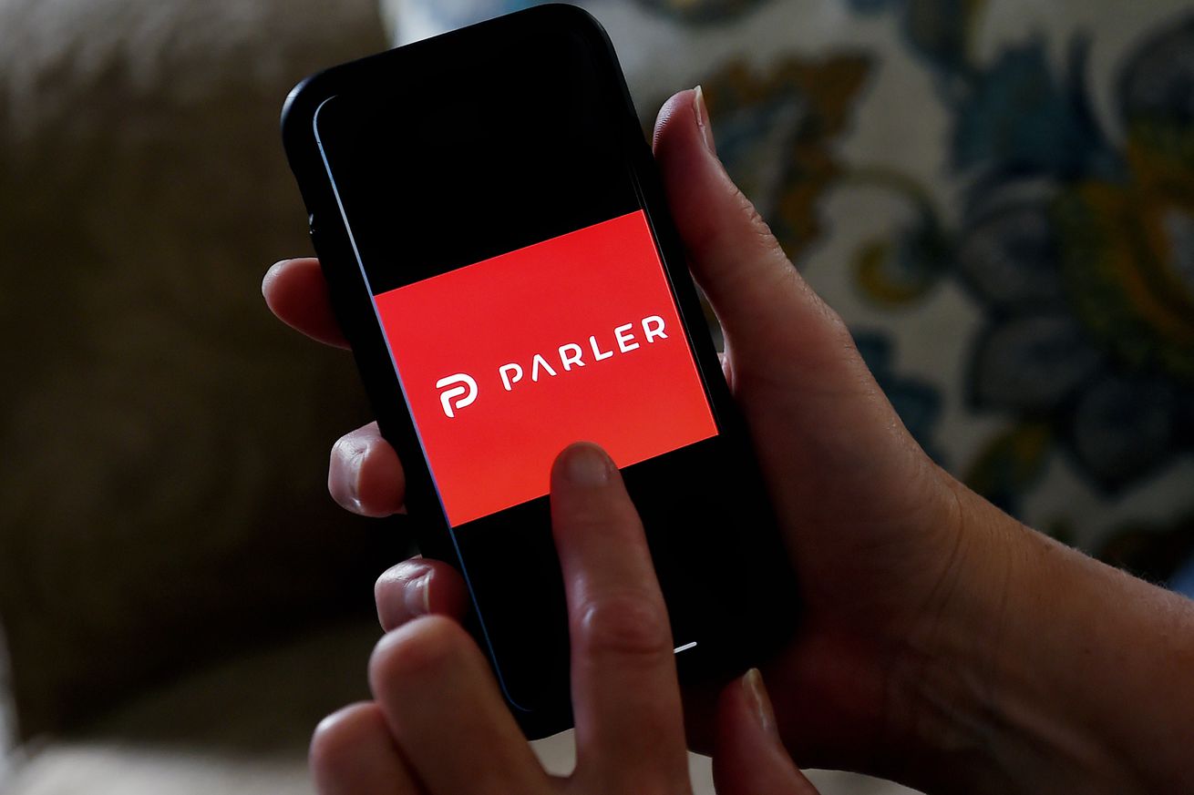 This illustration picture shows social media application logo from Parler displayed on a smartphone in Arlington, Virginia on July 2, 2020. - Amid rising turmoil in social media, recently formed social network Parler is gaining with prominent political conservatives who claim their voices are being silenced by Silicon Valley giants. 