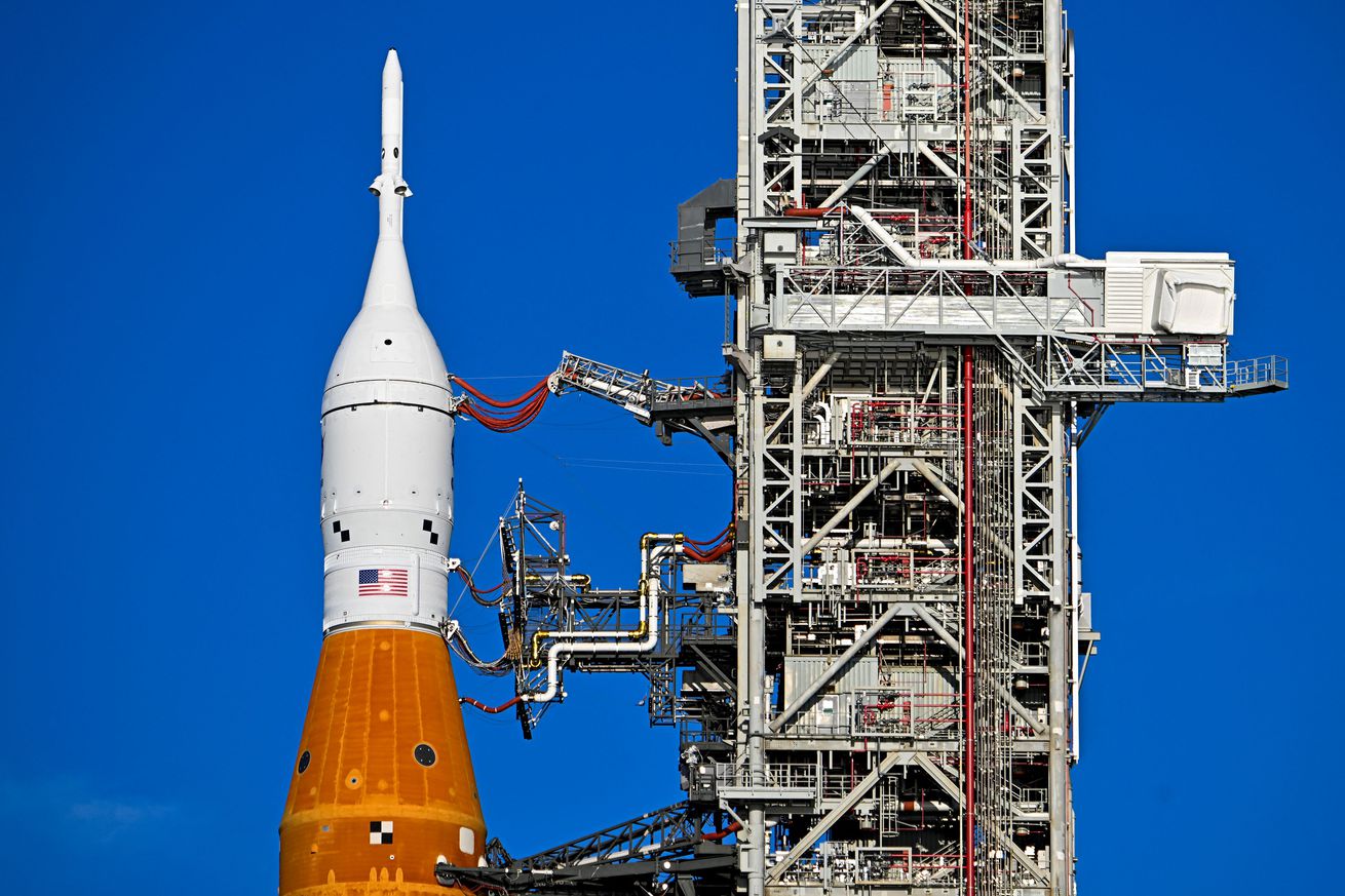 A close-up image of the Artemis I rocket against a clear sky