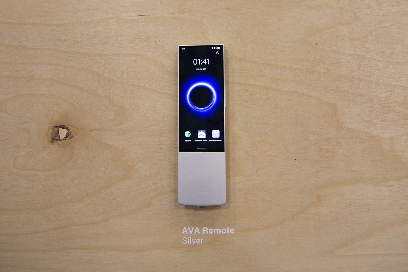 A silver touchscreen remote on a wooden background